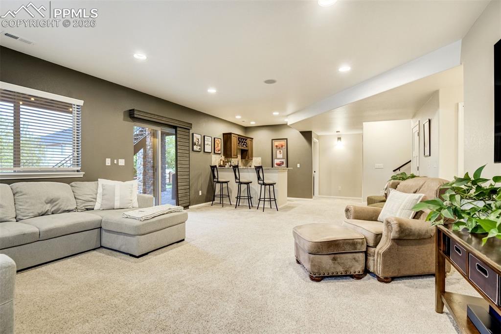 Image 38 of 48: Spacious recreation room featuring recessed lighting and neutral carpeting