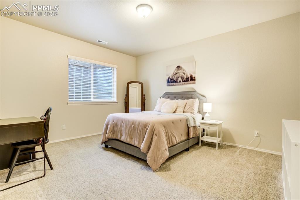 Image 43 of 48: Basement bedroom 2 Carpeted room with neutral wall tones and a single windo