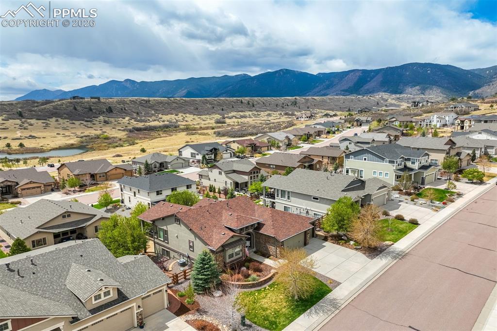 Image 6 of 48: Expansive residential area featuring mountain backdrop and distant body of