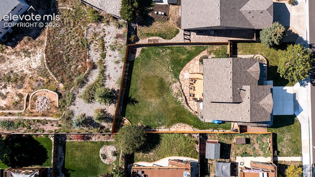 Image 6 of 50: Aerial perspective of property featuring a fenced backyard, lawn space, sto