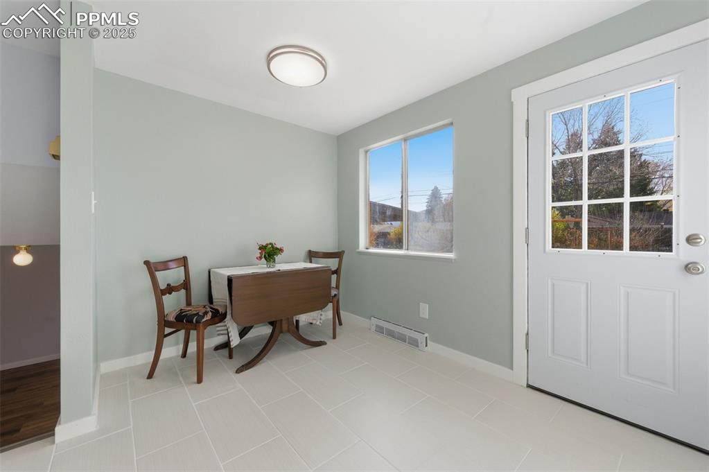 Image 11 of 38: Dining room featuring baseboards and light tile patterned floors