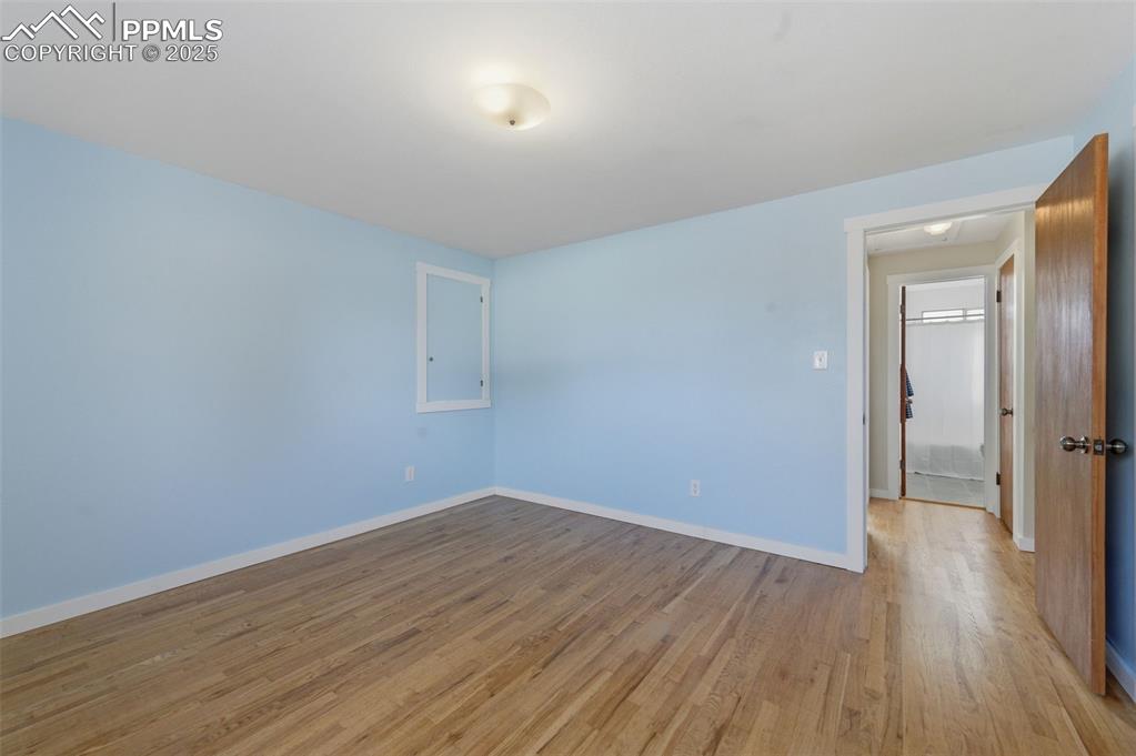 Image 13 of 38: Empty room featuring wood finished floors and baseboards
