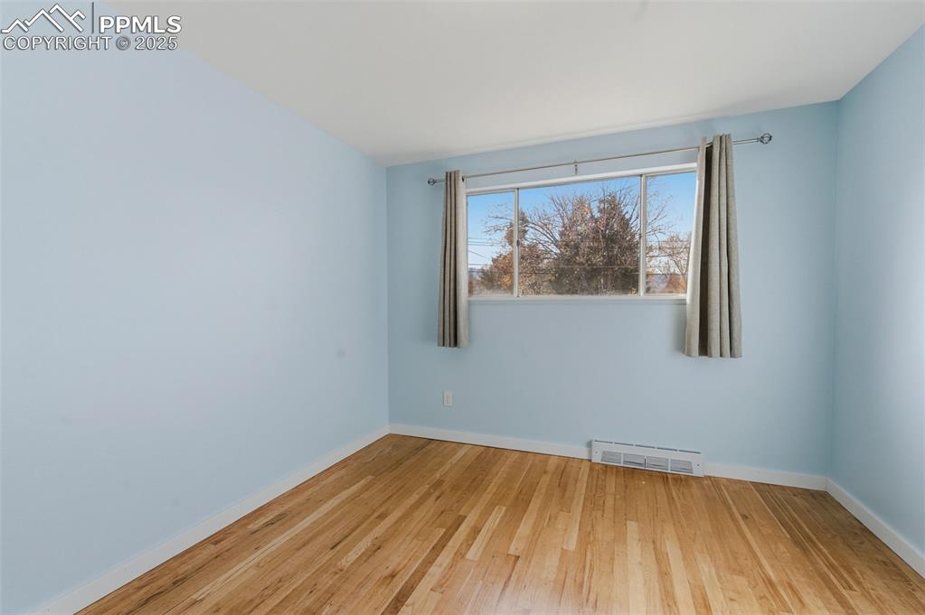 Image 16 of 38: Spare room featuring light wood-style flooring and baseboards