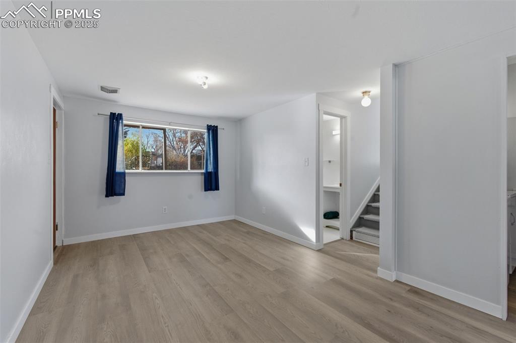 Image 19 of 38: Spare room featuring light wood finished floors and stairs