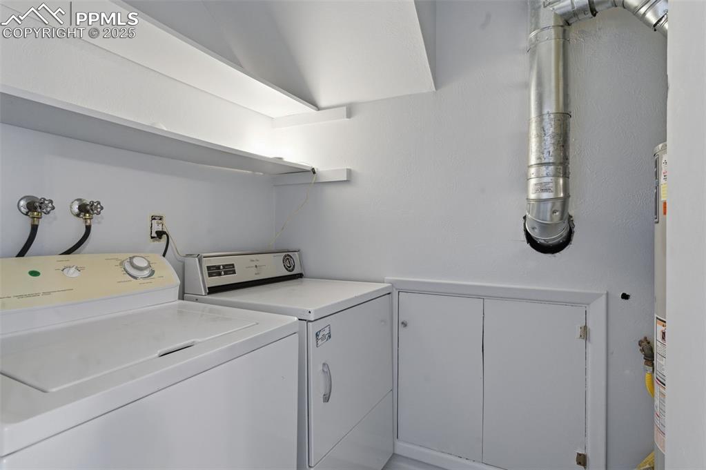 Image 21 of 38: Washroom featuring separate washer and dryer