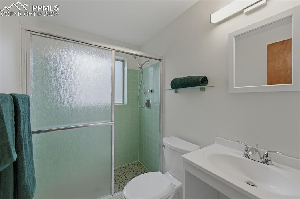 Image 22 of 38: Full bathroom with vanity and a stall shower