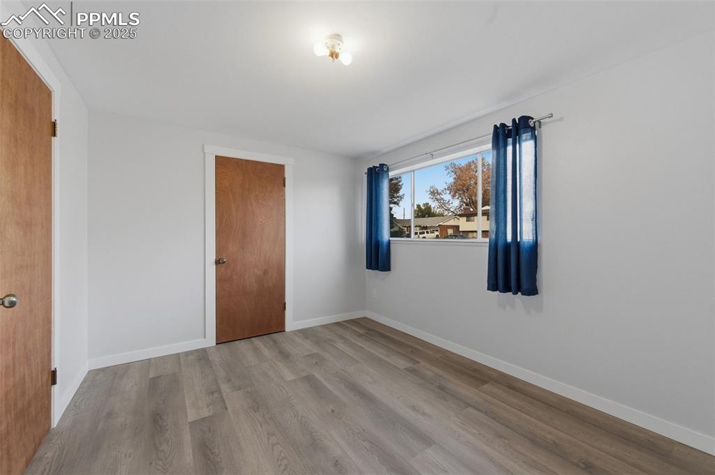 Image 25 of 38: Unfurnished room with light wood-type flooring and baseboards
