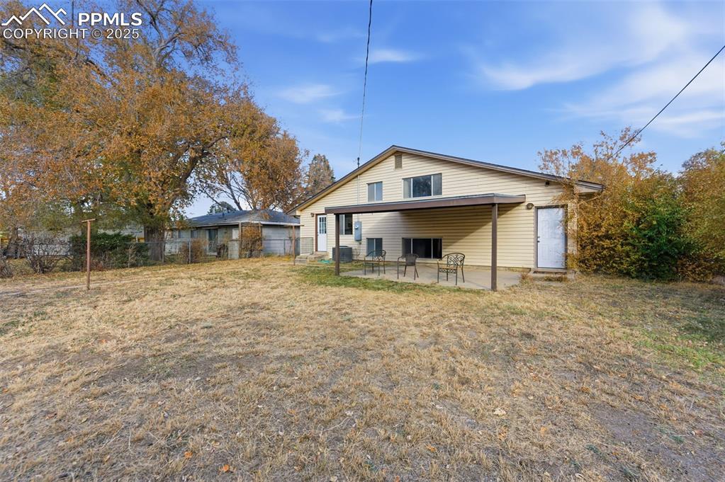 Image 28 of 38: Rear view of property with a patio area and a garage