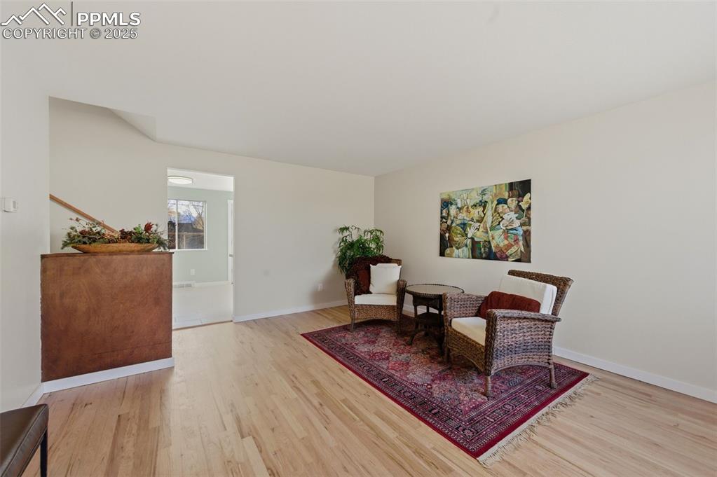 Image 5 of 38: Living room with wood finished floors