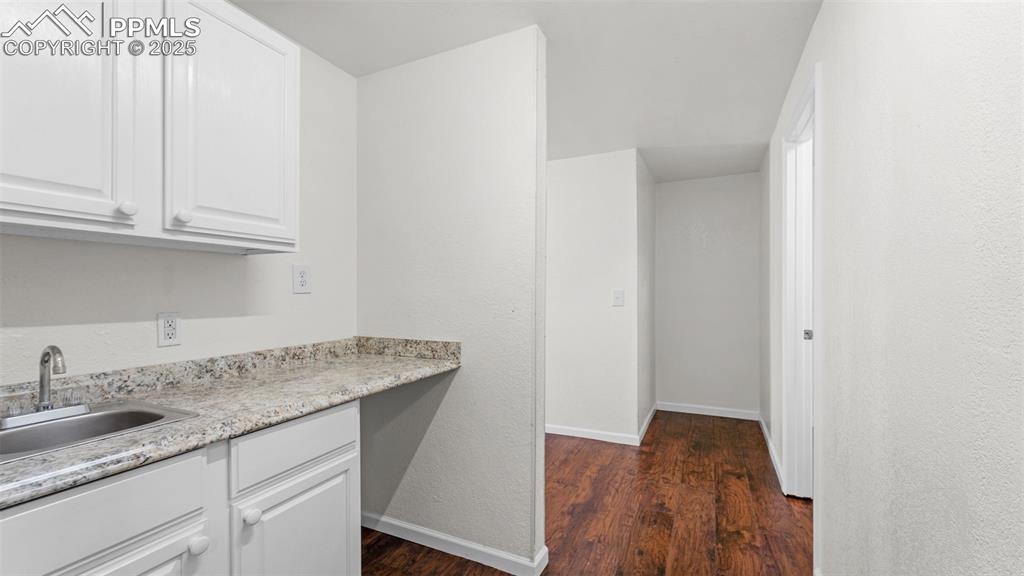 Image 14 of 50: Sink and a textured wall at basement