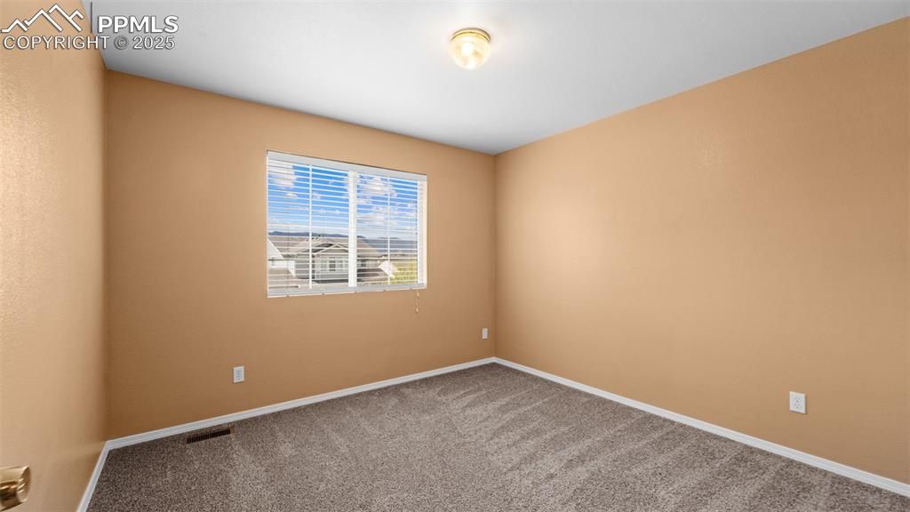 Image 16 of 50: Unfurnished room with carpet floors and baseboards