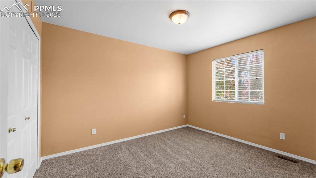 Image 17 of 50: Carpeted empty room with baseboards