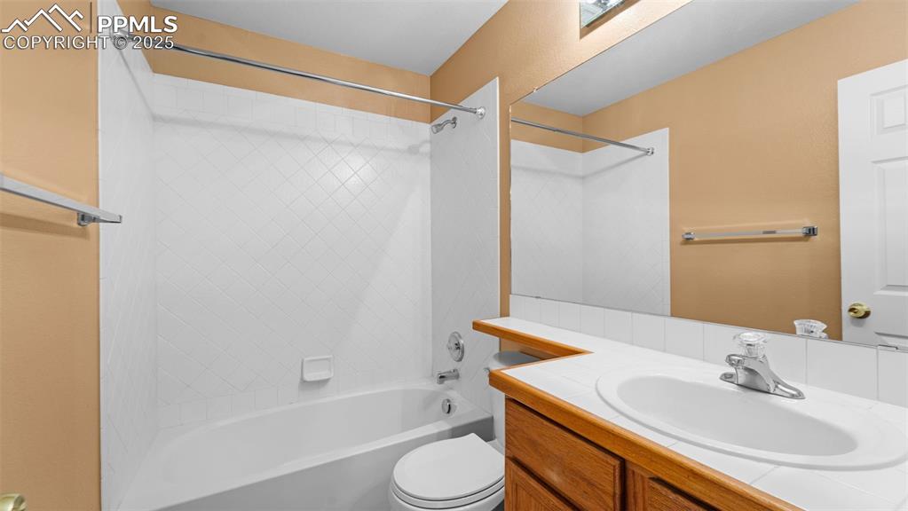 Image 18 of 50: Full bath featuring bathing tub / shower combination and vanity