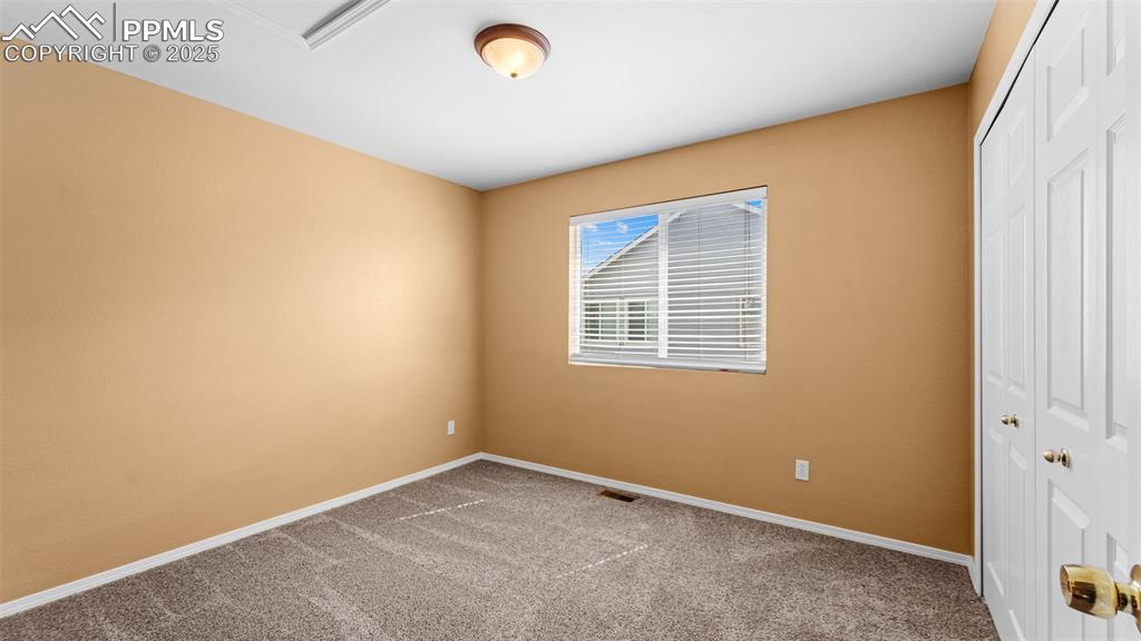 Image 19 of 50: Unfurnished bedroom with a closet and light colored carpet