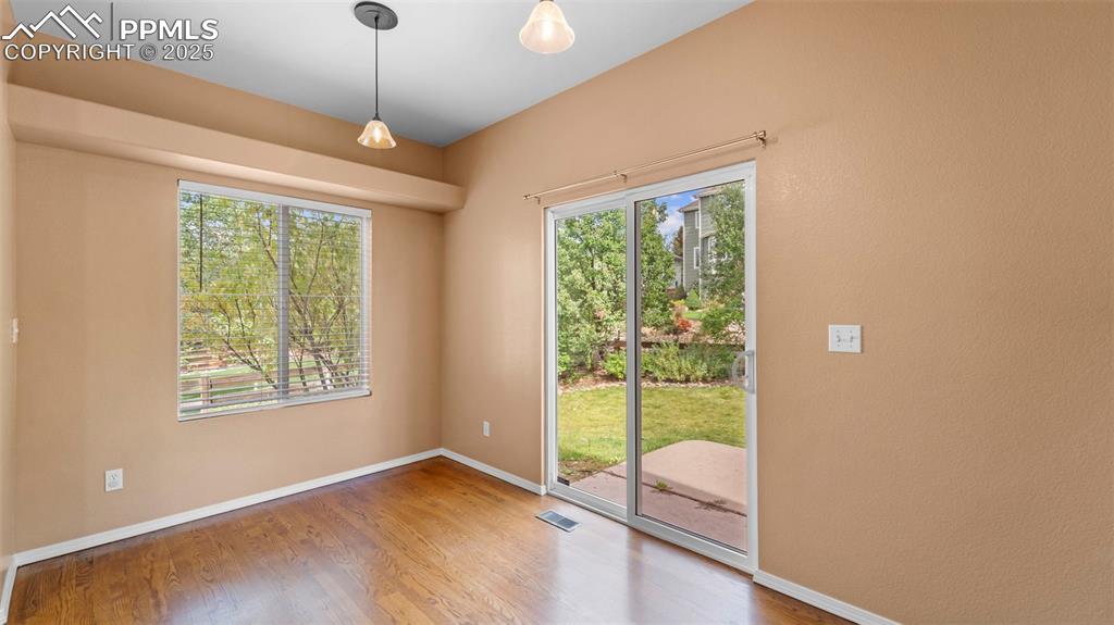 Image 27 of 50: Sliding door tofeaturing wood finished floors and baseboards