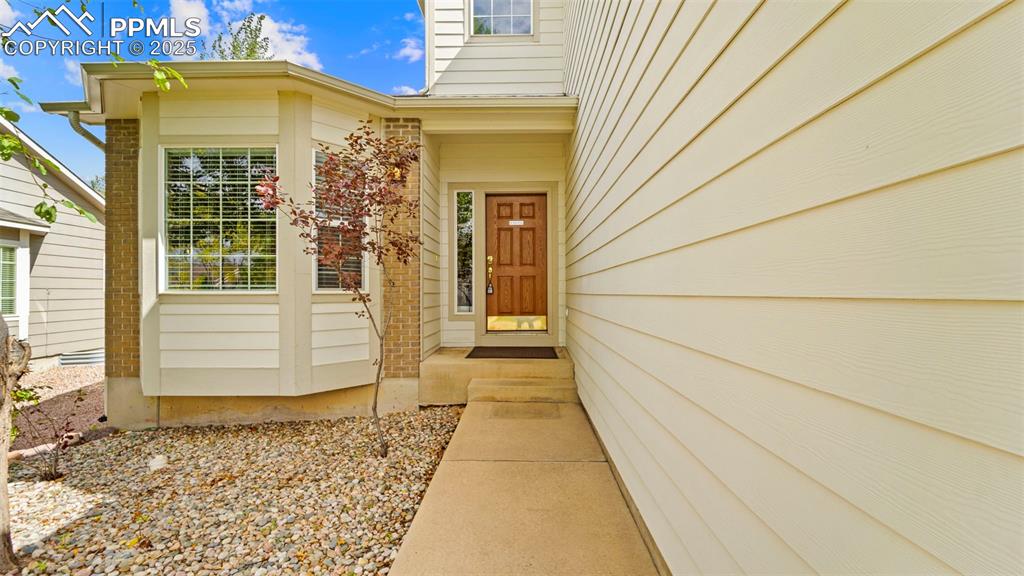 Image 32 of 50: Entrance to property with brick siding