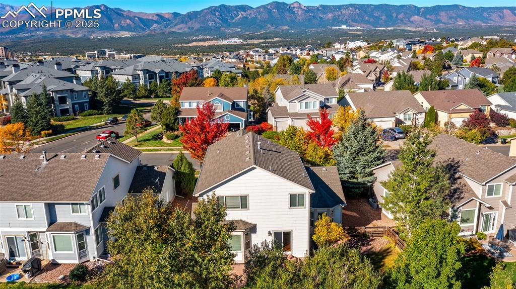 Image 38 of 50: Aerial view of residential area featuring mountains