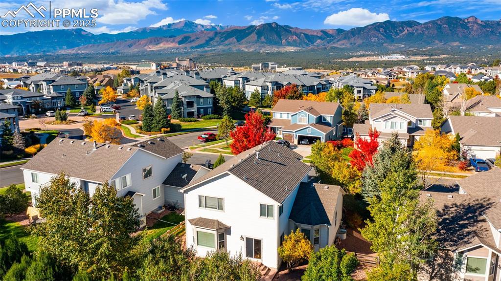 Image 39 of 50: Aerial perspective of suburban area featuring a mountainous background