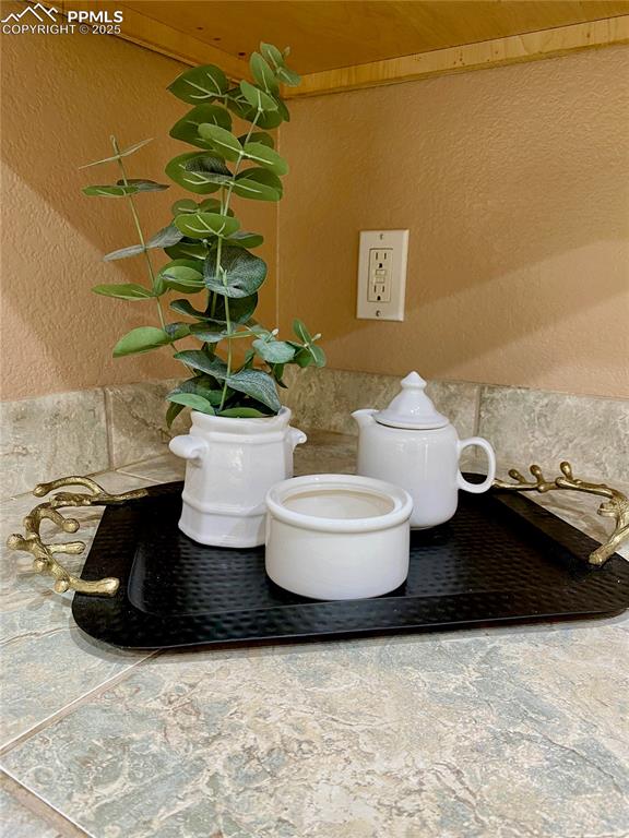 Image 47 of 50: textured wall, tile walls, and wainscoting