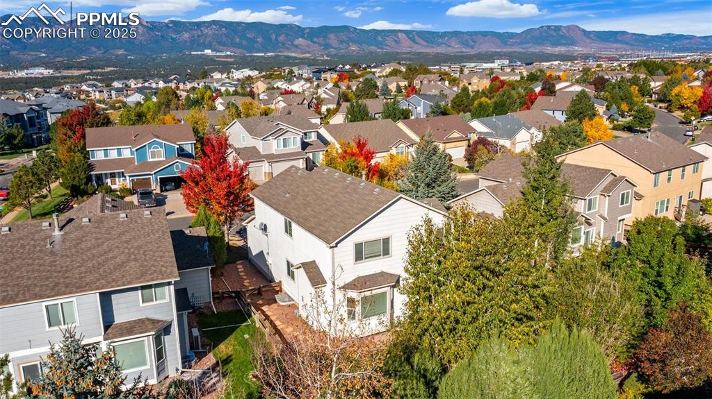 Image 5 of 50: Aerial view of residential area featuring a mountain backdrop
