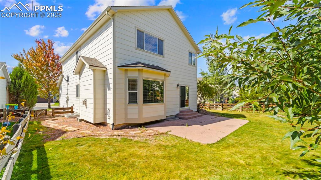 Image 7 of 50: Back of property featuring a patio