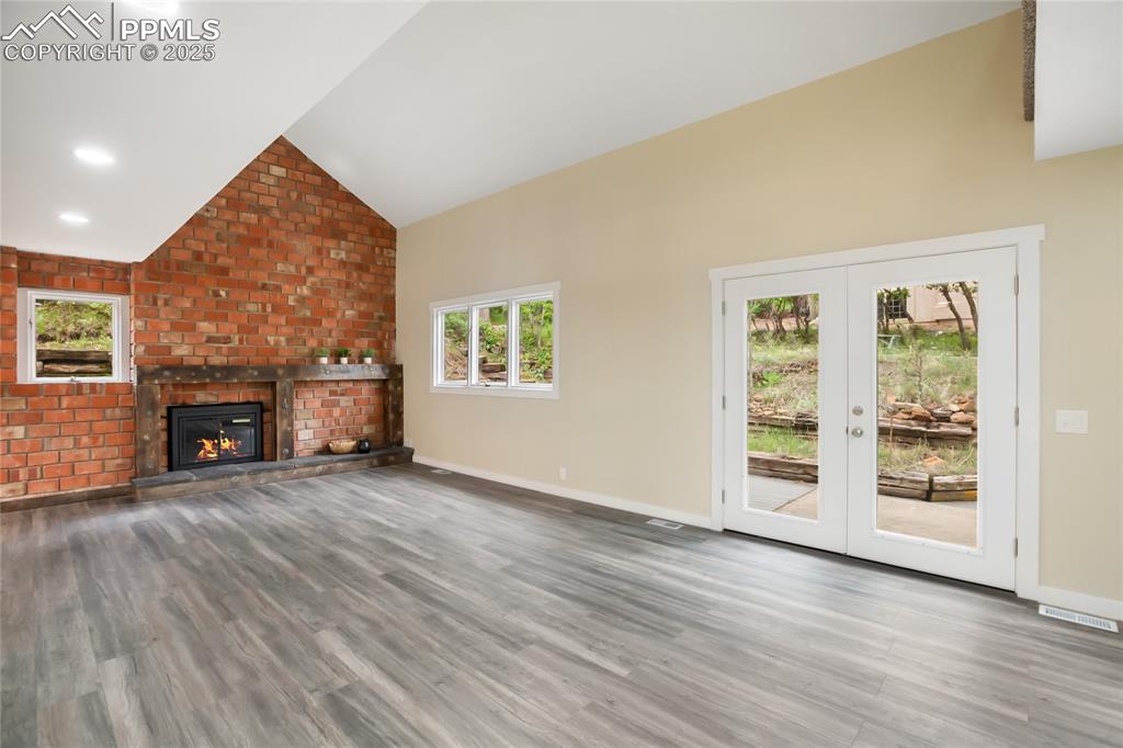 Image 13 of 37: Beautiful full wall fireplace focal point with walk out to back patio
