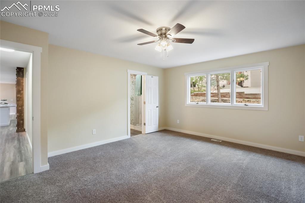 Image 15 of 37: Main level primary with big windows and lots of room!