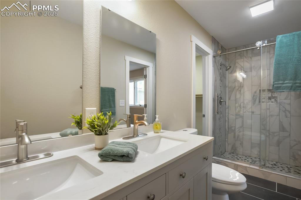 Image 18 of 37: All new Primary bathroom with walk in shower, waterfall tile accents, dual 