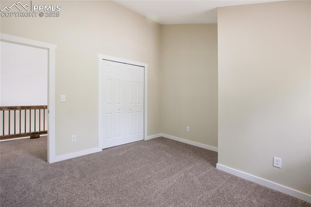 Image 28 of 37: Upper level one of two bedrooms