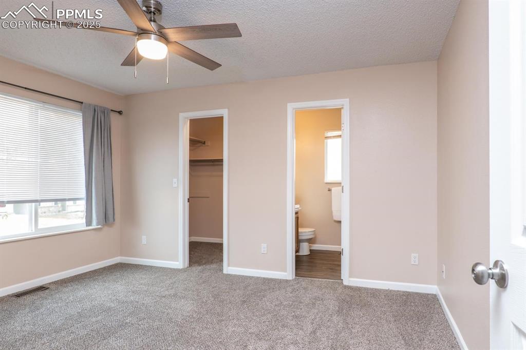 Image 10 of 26: Retreat to the primary suite featuring a adjoining full bath and a generous