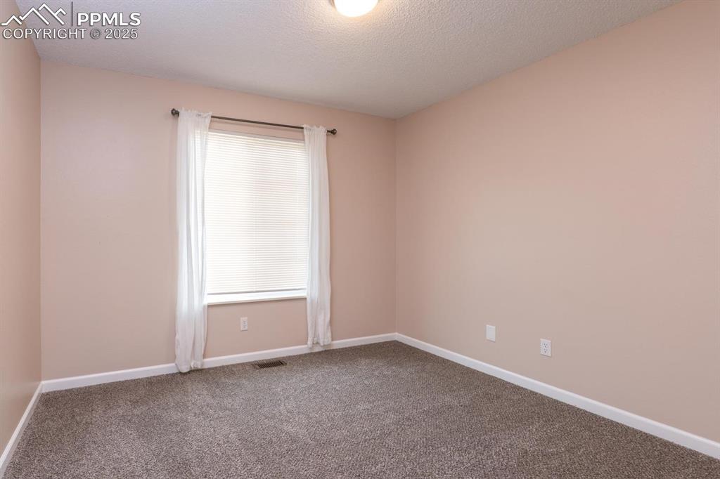Image 17 of 26: 3rd main level bedroom with new carpet and closet.