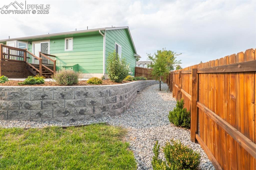 Image 21 of 26: Full privacy fence in the back yard has been newly stained.
