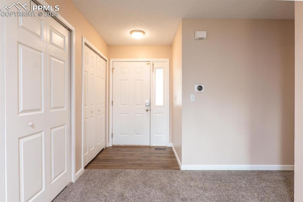 Image 3 of 26: Welcoming front entry with luxury plank flooring and spacious entry closet.