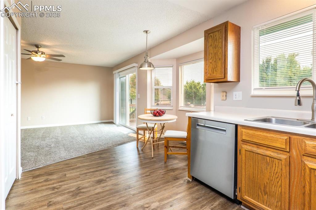 Image 7 of 26: The light and bright kitchen flows to the open living room.