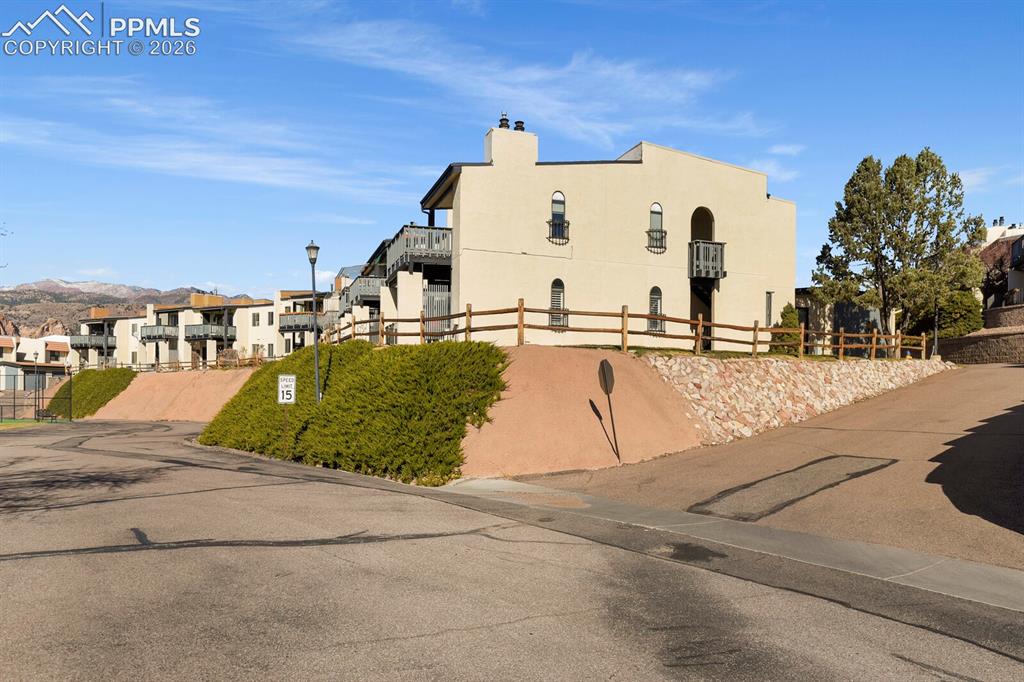 Image 1 of 27: Multi-level stucco building featuring arched windows, private balconies, an