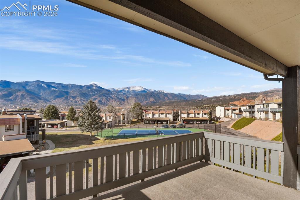 Image 26 of 27: Private balcony with concrete flooring and mountain scenery