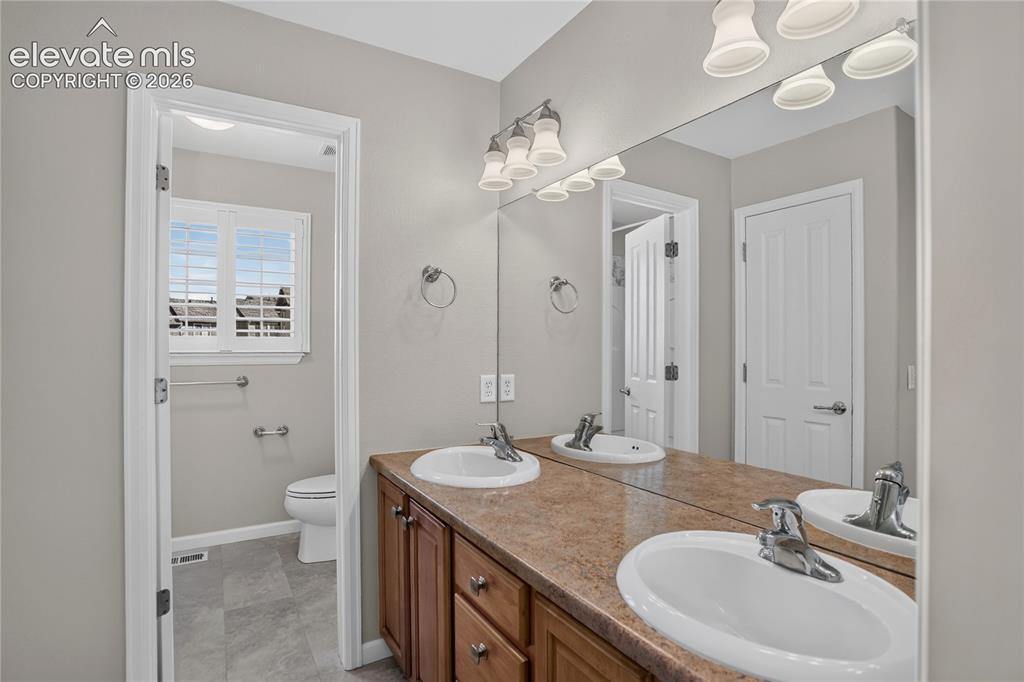 Image 29 of 42: Ensuite Primary Bath and Walk-in Closet