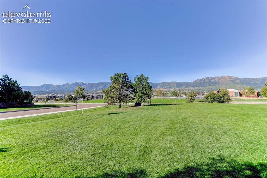 Image 3 of 42: Greenspace in front of unit and view of the AFA and mountains beyond.