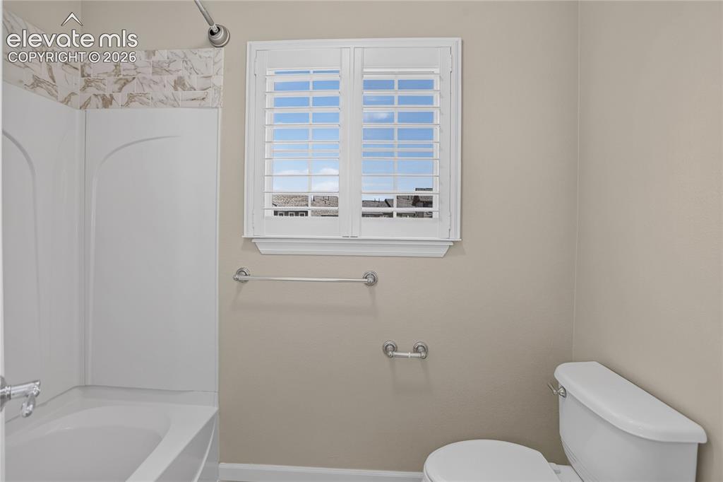 Image 30 of 42: Ensuite Primary Bath and Walk-in Closet