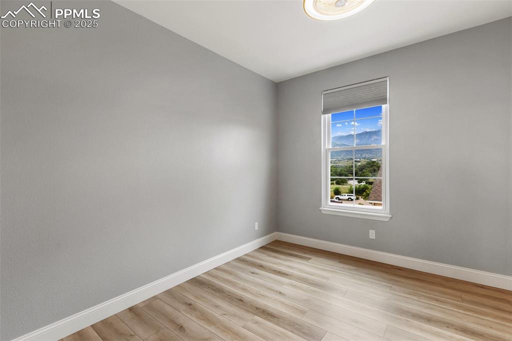 Image 31 of 44: Upstairs bedroom #3 with mountain views in upper unit