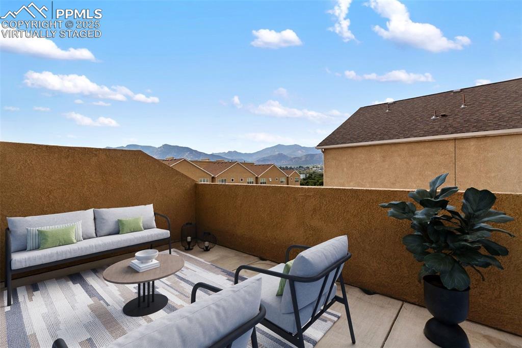 Image 7 of 44: Primary suite deck with mountain views. Virtually Staged