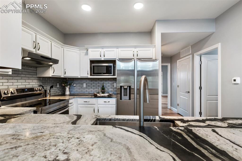 Image 8 of 44: Upper unit - Remodeled kitchen with spectacular stone countertops