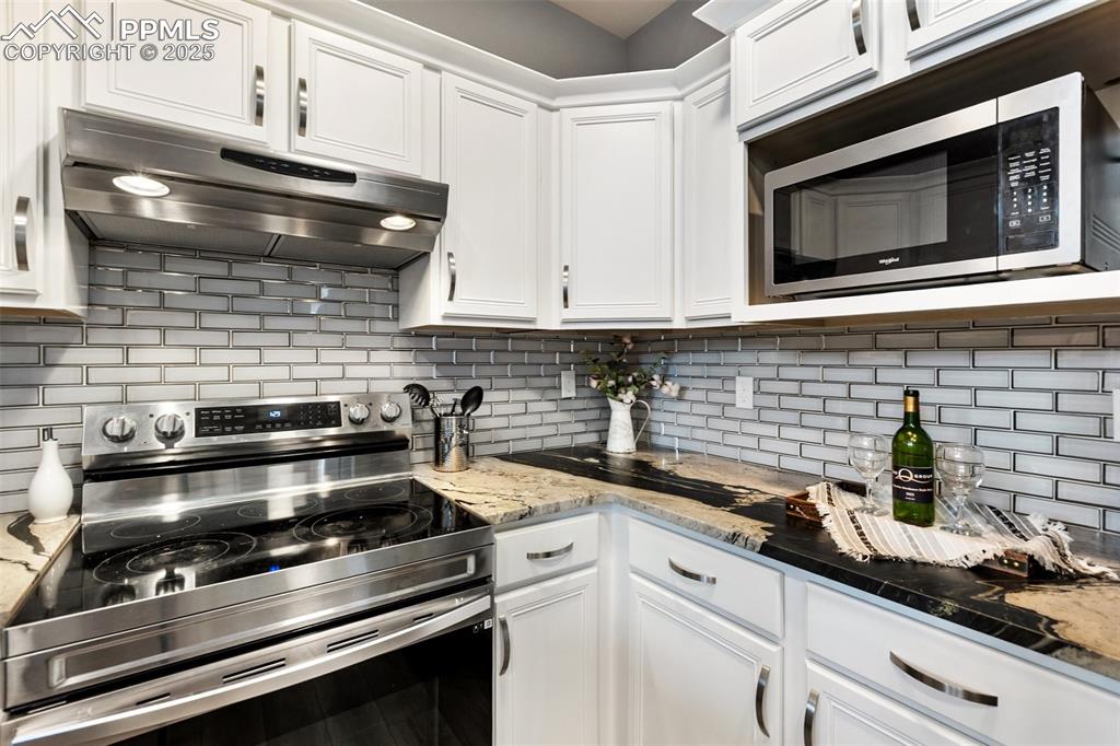 Image 9 of 44: Remodeled with stainless appliances and glass backsplash