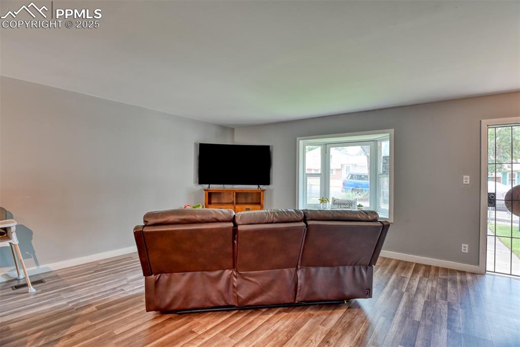 Image 14 of 37: Living room with light wood-style flooring and plenty of natural light