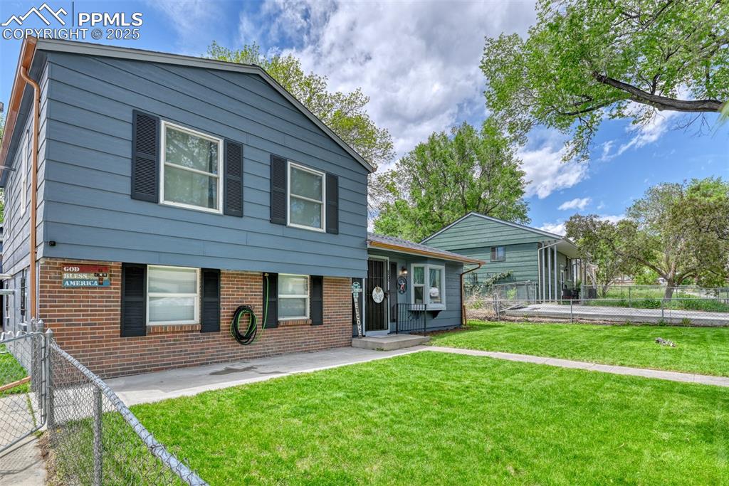 Image 2 of 37: Split level home with brick siding