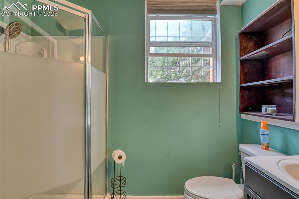 Image 20 of 37: Bathroom featuring a shower stall and vanity