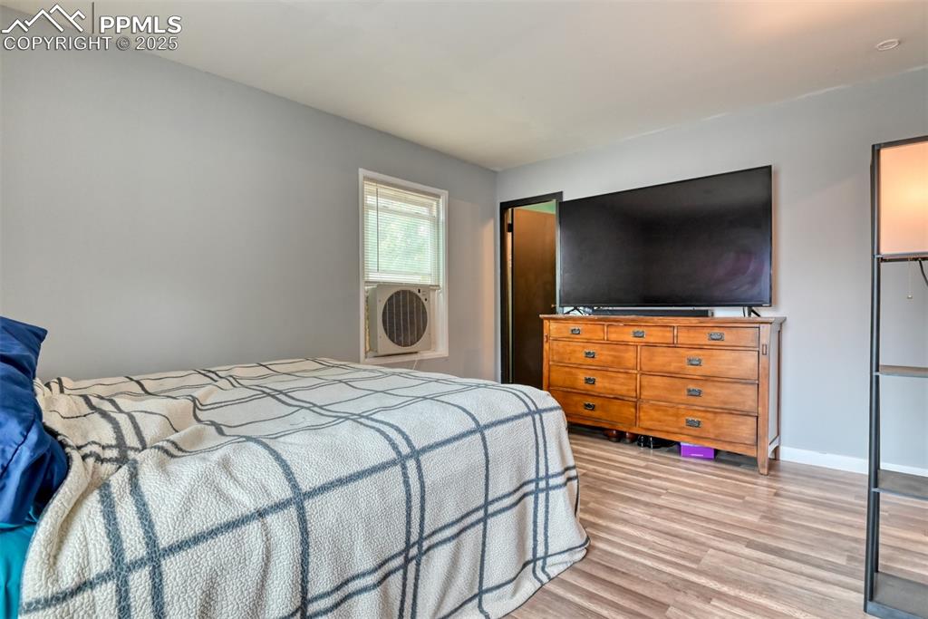 Image 24 of 37: Bedroom with light wood-type flooring and baseboards
