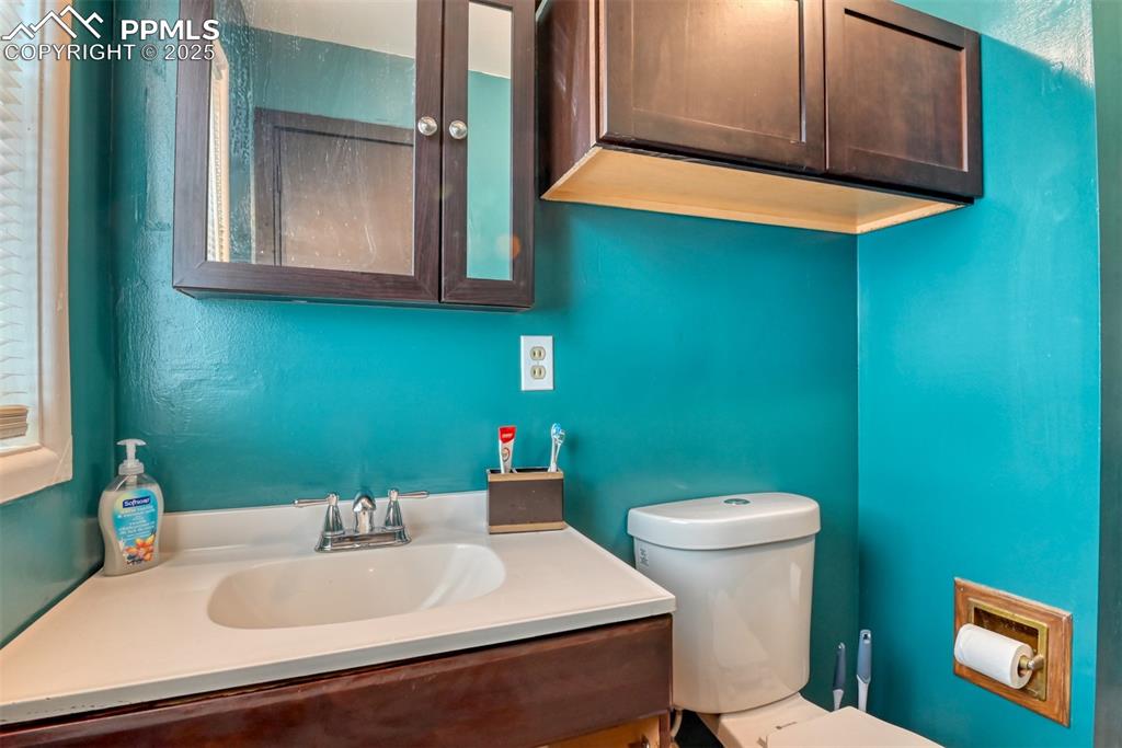 Image 28 of 37: Bathroom with vanity and a textured wall