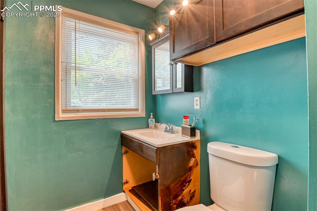 Image 29 of 37: Half bath with vanity and toilet