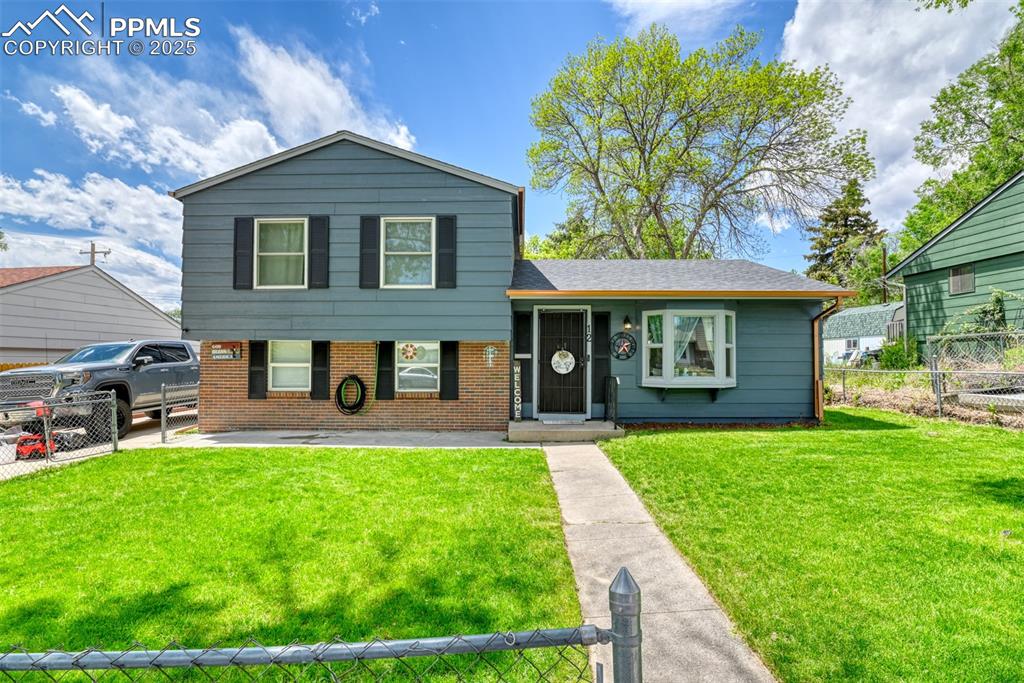 Image 3 of 37: Tri-level home with brick siding and roof with shingles